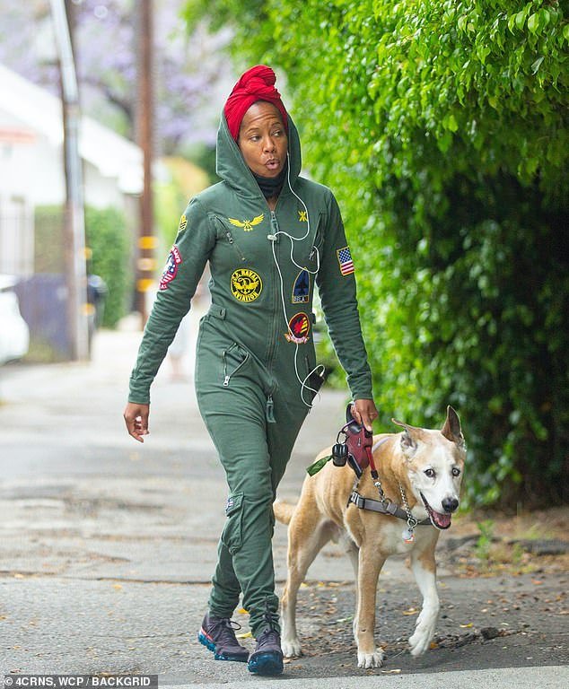 Regina King takes a walk with her dog Cornbread while wearing a red