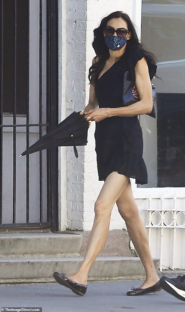 Famke Janssen turns heads in black mini dress as she takes a stroll in
