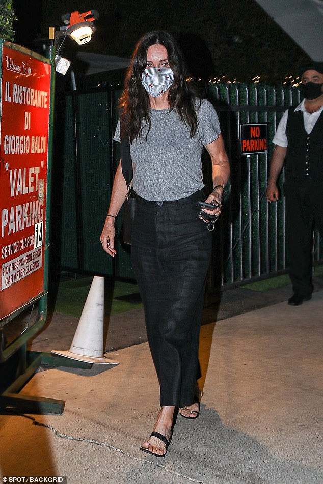 Courteney Cox masks up and wears wide-leg jeans to dine al ...